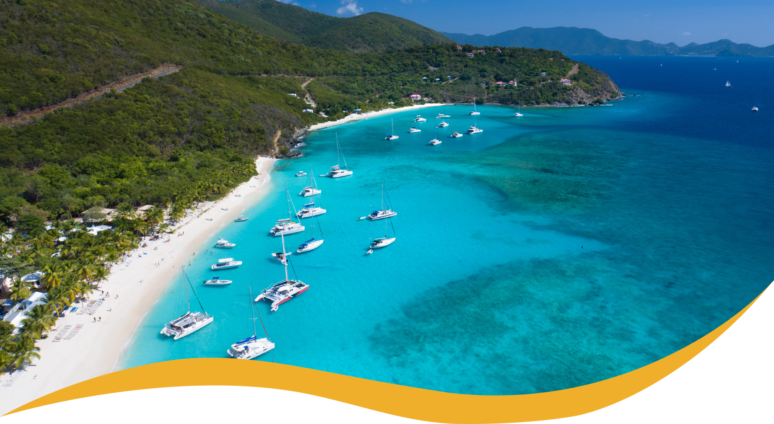 Charter Smarter crewed yacht charters in the Virgin Islands, aerial view of a turquoise bay with anchored yachts
